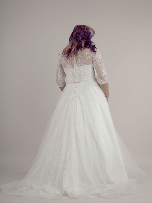 Back veiw of strapless wedding dress with matching lace jacket.