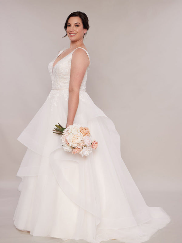 Plus size wedding dresses in Blush with layered skirt and straps.