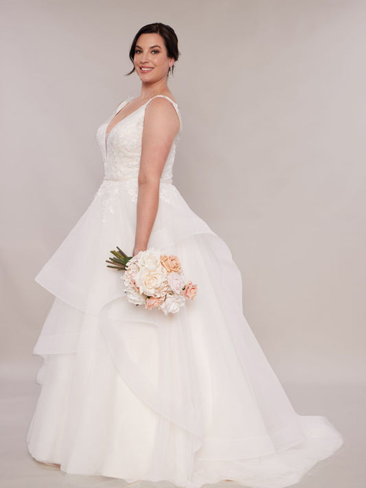 Plus size wedding dresses in Blush with layered skirt and straps.