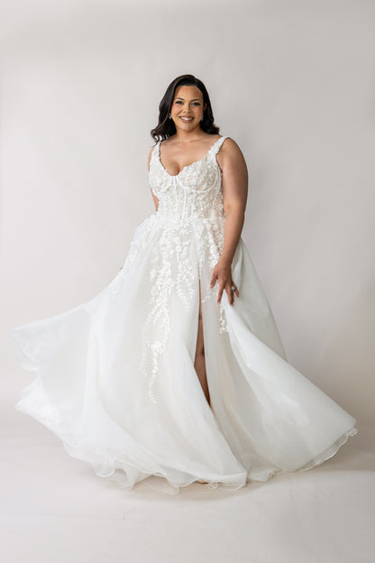 Tiana lace wedding dress in motion with full skirt and front split