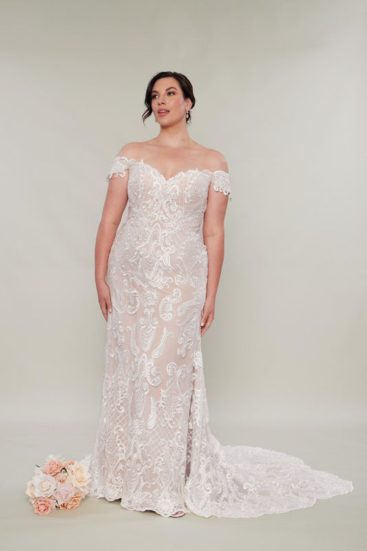 Lace sheath wedding dresses ivory on nude satin with a train and off the shoulder straps.