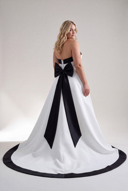 Roxie white wedding dress with dramatic black bow and train
