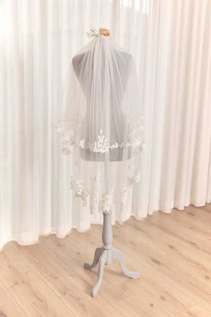 Double layer lace trim fingertip veil featuring leaf design lace trim. By plus size perfection bridal.