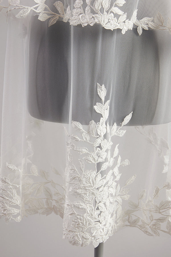 Close up Detailed leaf lace edging a pale ivory wedding veil.