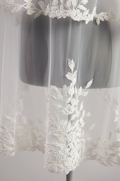 Close up Detailed leaf lace edging a pale ivory wedding veil.