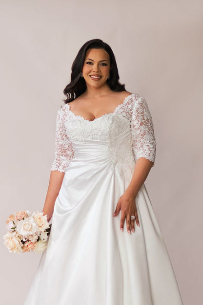 Floral lace bodice and gathered satin waist on the Priya wedding dress
