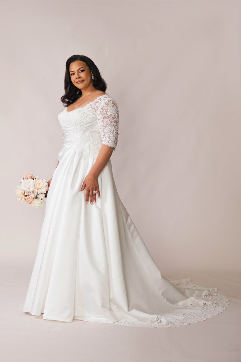 Plus size lace sleeve wedding dress with full satin skirt and lace train