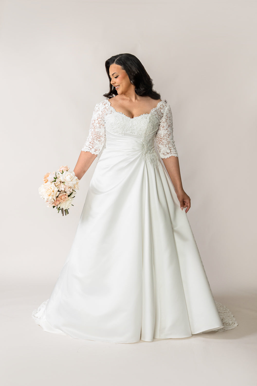 Ivory satin A-line wedding dress with lace sleeves and sweetheart neckline