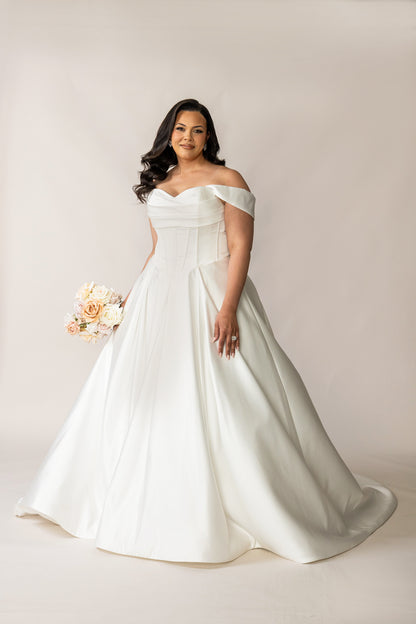Full-length Deluxe Holly satin wedding dress with a full pleated skirt